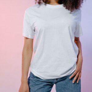 Close-up of a person in a white t-shirt and jeans, featuring modern fashion styling.